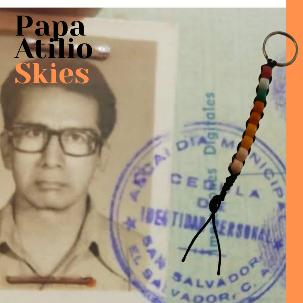 Handmade bead keychain with Italian and Mexican flag colors representing family travel trips, combined with sunset-colored beads symbolizing Papa Atilio skies, created by a grandson as a tribute to cultural roots and generational memories.